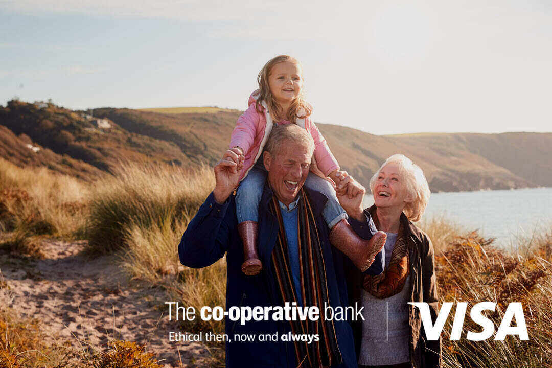Family enjoying outdoors, co-operative bank and visa logo